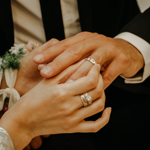 mens traditional ring being put on my woman