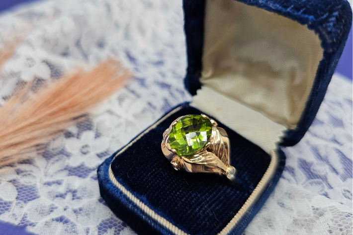 peridot in jewelry ring in antique box