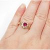 1.13 ctw Created Ruby and Faux Diamond Halo Ring 14k Gold on hand